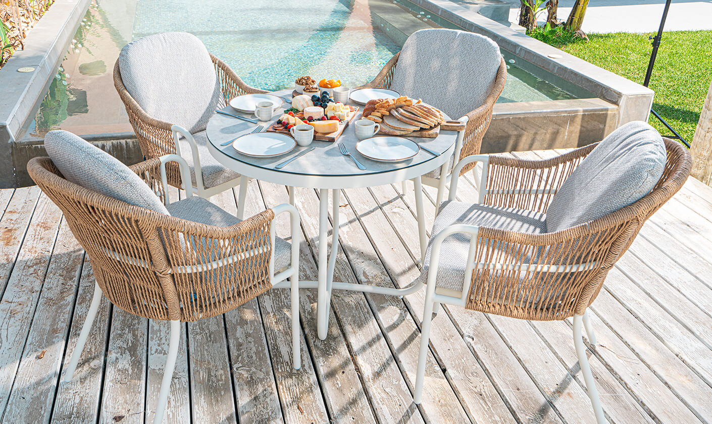 Transform your backyard into an outdoor escape with cozy furniture and serene accents.